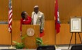 Dean Cynthia Nance of the School of Law and Chancellor Charles Robinson unveil proclamations from Arkansas Gov. Sarah Sanders and Fayetteville Mayor Lioneld Jordan as the start of the law school's centennial year.