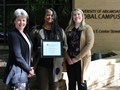 LaShanda Owens, center, accepts the Global Campus Employee of the Quarter award from Cheryl Murphy, vice provost for distance education and head of the Global Campus (left), and Jamie Loftin, assistant vice provost for distance education administration (right).