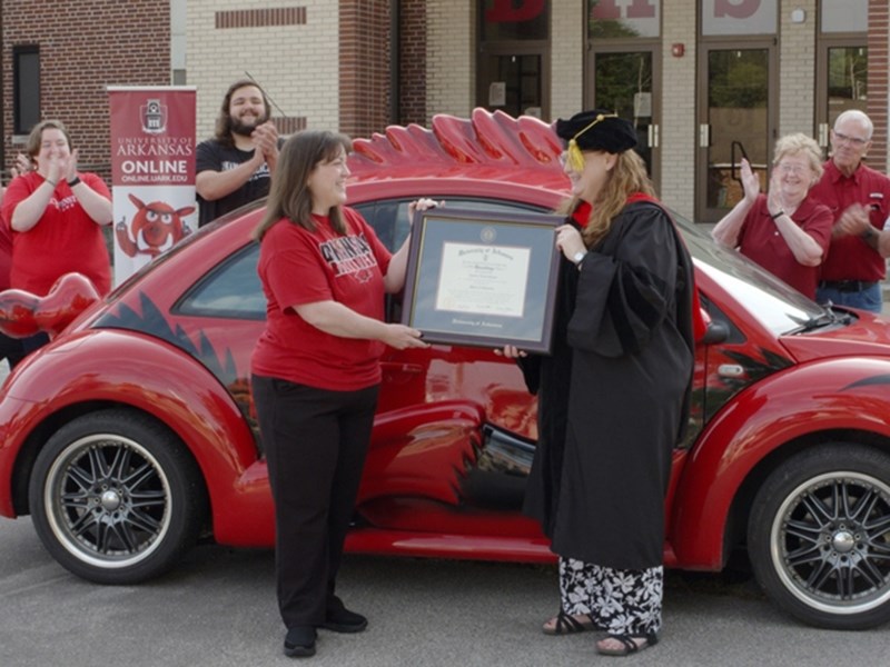 Candice Groves receives her framed diploma from Patty Milner, assistant vice provost for innovation and the online student experience, during the Razorbug Diploma Tour on June 28 at Blytheville High School.