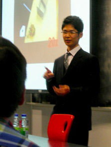 Honors engineering/psychology student Akihiro Eguchi presents research on a housecleaning robot prototype at a conference in Montreal, Canada.
