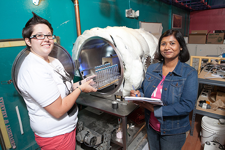 Graduate students Rebecca Mickol and Navita Sinha prepare to load methanogens into the Pegasus Chamber housed in W.M. Keck Laboratory in the Old Museum Building.