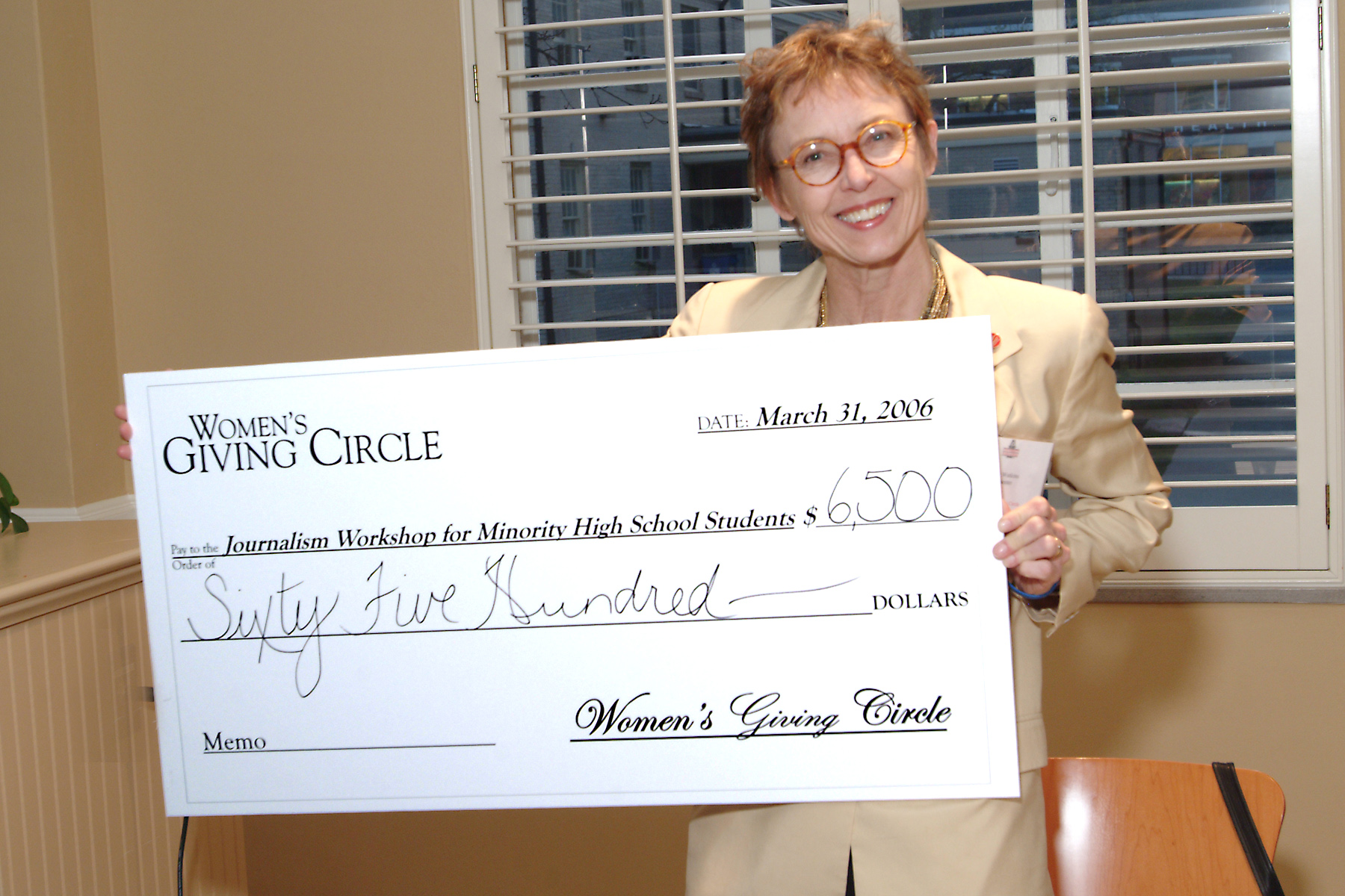 Patsy Watkins, Chair of the Dept. of Journalism in the Fulbright College, accepts a check from the Women&rsquo;s Giving Circle.