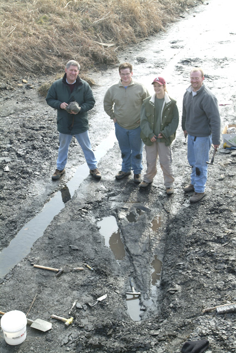 From left, geology professor Walter Manger, junior Jonathan Gillip, freshman Sarah Kee and senior Kevin Morgan with the cone-shaped actinoceratoid nautiloid fossil.